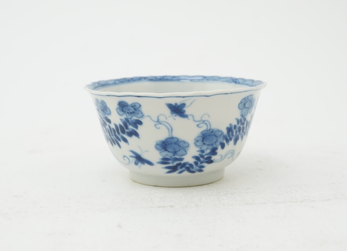 A Chinese blue and white tea bowl and saucer, Kangxi period